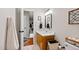 Bathroom featuring a wood vanity cabinet, modern mirror, and stylish decor at 902 Loop Rd, Clayton, NC 27527