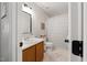 Bright bathroom features a wood vanity, decorative mirror and a shower and tub combination at 902 Loop Rd, Clayton, NC 27527