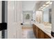 Well-lit bathroom with double vanity, ample counter space, and soaking tub in the background at 902 Loop Rd, Clayton, NC 27527