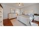 Bright bedroom featuring wood floors, neutral walls, ceiling fan, and plantation shutters at 902 Loop Rd, Clayton, NC 27527