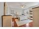 Bright bedroom featuring wood floors, neutral walls, ceiling fan, and plantation shutters at 902 Loop Rd, Clayton, NC 27527