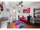 Bedroom with hardwood floors, ceiling fan, hockey-themed decor and lots of natural light at 902 Loop Rd, Clayton, NC 27527