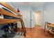 Bedroom with a loft bed, hardwood floors, and a view of the hallway at 902 Loop Rd, Clayton, NC 27527