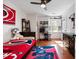 Bedroom with hardwood floors, ceiling fan, and ample natural light streaming through plantation shutters at 902 Loop Rd, Clayton, NC 27527