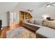 Expansive bonus room with hardwood floors, custom shelving and a comfortable seating area with a large rug at 902 Loop Rd, Clayton, NC 27527