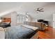 Bonus room includes a bed, work area, and a large sectional sofa for relaxation or entertainment at 902 Loop Rd, Clayton, NC 27527