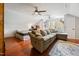 Spacious bonus room with hardwood floors, ceiling fans, sofa, and a desk for flexible use at 902 Loop Rd, Clayton, NC 27527