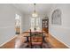 Dining room featuring hardwood floors, a large farmhouse-style table and an antique china cabinet at 902 Loop Rd, Clayton, NC 27527