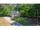 Charming home featuring lush landscaping, a well-maintained lawn, and an American flag waving in the yard at 902 Loop Rd, Clayton, NC 27527