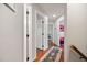 The hallway provides access to various rooms and features hardwood floors and neutral wall color at 902 Loop Rd, Clayton, NC 27527