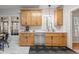 Well-lit kitchen features stainless steel appliances, light wood cabinets, and ample counter space at 902 Loop Rd, Clayton, NC 27527