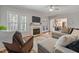 Bright living room boasts hardwood floors, a cozy fireplace, and an open view to the kitchen at 902 Loop Rd, Clayton, NC 27527