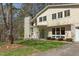 Two-story home with modern architecture, a well-kept lawn, and vibrant green accents at 912 Cheviot Ave, Durham, NC 27707