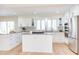 Bright, modern kitchen with white cabinets, stainless steel appliances, and a functional center island at 912 Cheviot Ave, Durham, NC 27707