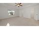 Main bedroom featuring neutral carpeting, tray ceiling, and an open doorway into a closet at 957 Vandalia Dr, Cary, NC 27519