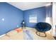 Cozy bedroom featuring blue walls, a comfortable chair, and neutral carpet at 992 Ambergate, Apex, NC 27502