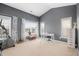 Bright bedroom featuring gray walls, two windows, and an exercise bike by the window at 992 Ambergate, Apex, NC 27502