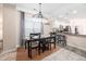 Dining room with modern chandelier lighting, kitchen bar, and ample natural lighting at 992 Ambergate, Apex, NC 27502