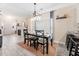 Open dining area adjacent to the kitchen with a modern light fixture and plenty of natural light at 992 Ambergate, Apex, NC 27502