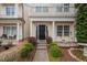 Charming home featuring a black front door, elegant columns, and beautiful landscaping at 992 Ambergate, Apex, NC 27502