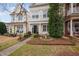 Beautiful home with manicured front yard, a charming black front door, and a delightful bird bath feature at 992 Ambergate, Apex, NC 27502