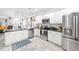 Well-lit kitchen features stainless appliances, granite countertops, and painted cabinets at 992 Ambergate, Apex, NC 27502