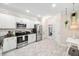 Well-lit kitchen features stainless appliances, granite countertops, and painted cabinets at 992 Ambergate, Apex, NC 27502