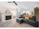 Open-concept living room with a fireplace, a plush sofa, and modern flooring at 992 Ambergate, Apex, NC 27502