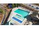 Aerial view of a community pool with lounge seating next to a neighborhood road at 992 Ambergate, Apex, NC 27502