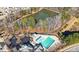 Aerial view of community pool next to a pond, parking, and wooded area at 992 Ambergate, Apex, NC 27502