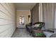 Enclosed porch featuring wicker chairs and tile flooring, offering a relaxing outdoor space at 992 Ambergate, Apex, NC 27502