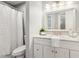 Well-lit bathroom featuring a marble vanity, framed mirror, and shower with curtain at 100 Hunting Chase # 1-B, Cary, NC 27513