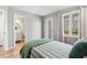 Bedroom featuring a comfortable bed and door leading to a deck with wooded scenery at 100 Hunting Chase # 1-B, Cary, NC 27513