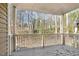 Relaxing covered deck with view into the surrounding forest and natural area at 100 Hunting Chase # 1-B, Cary, NC 27513