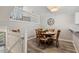 Cozy dining area with a round table set for six, next to an open loft space at 100 Hunting Chase # 1-B, Cary, NC 27513