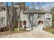 Charming townhouse showcasing a well-maintained exterior with a welcoming front porch and manicured landscaping at 100 Hunting Chase # 1-B, Cary, NC 27513