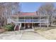 Charming two-story house featuring a spacious wraparound porch, red metal roof and brick foundation at 100 Hunting Chase # 1-B, Cary, NC 27513
