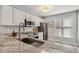 Bright kitchen featuring granite counters, stainless steel appliances and a modern sink fixture at 100 Hunting Chase # 1-B, Cary, NC 27513
