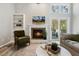 Bright living room featuring a fireplace, vaulted ceilings, large windows, and neutral decor at 100 Hunting Chase # 1-B, Cary, NC 27513