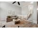 Bright living room with stairs to second level, neutral paint, decor and laminate floors at 100 Hunting Chase # 1-B, Cary, NC 27513