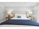 Serene main bedroom with natural light, calming colors, side tables and a ceiling fan at 100 Hunting Chase # 1-B, Cary, NC 27513