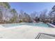 Large community swimming pool area with ample deck space and a covered pavilion, surrounded by mature trees at 100 Hunting Chase # 1-B, Cary, NC 27513