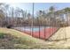 Outdoor tennis courts surrounded by trees, with a fence, providing a private and secluded playing experience at 100 Hunting Chase # 1-B, Cary, NC 27513