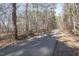 Paved walking trail lined with mature trees, perfect for a peaceful and scenic outdoor experience at 100 Hunting Chase # 1-B, Cary, NC 27513