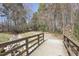 Scenic walking trail featuring a wooden bridge crossing a rocky stream, surrounded by lush greenery at 100 Hunting Chase # 1-B, Cary, NC 27513