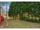 Landscaped backyard with a stone pathway and a view of the surrounding trees at 101 Whitney Ln, Durham, NC 27713