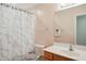 A full bathroom includes a marble-patterned shower curtain and wooden vanity at 101 Whitney Ln, Durham, NC 27713