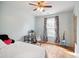 Bedroom features a desk, hardwood floors, and a window with patterned curtains for natural light at 101 Whitney Ln, Durham, NC 27713