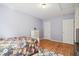 This bedroom has hardwood floors, light purple walls, and a black and floral patterned quilt at 101 Whitney Ln, Durham, NC 27713