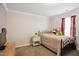 Cozy bedroom featuring carpet, a bed, a nightstand, and crown molding along the ceiling at 101 Whitney Ln, Durham, NC 27713